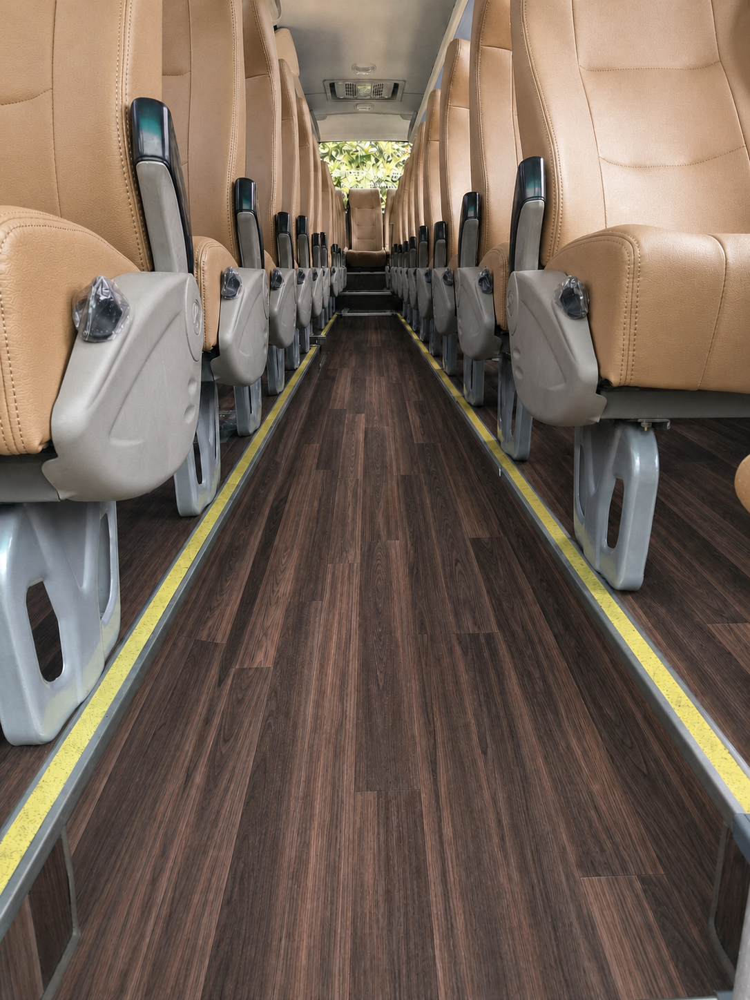 Dark woodgrain PVC flooring installed in a coach interior aisle
